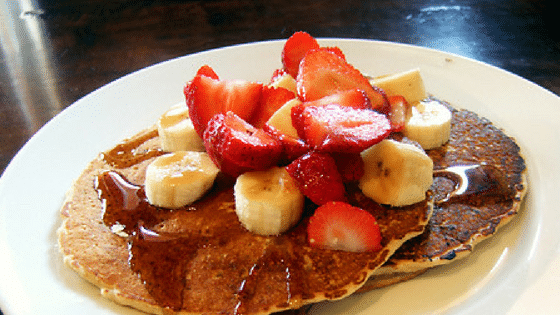 Pancakes toped with strawberries and banana slices